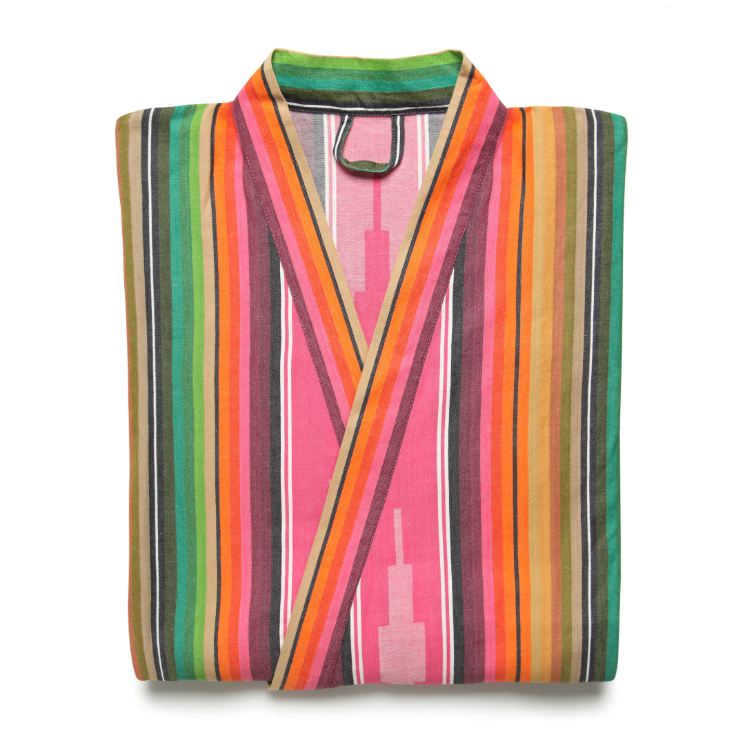 A folded multicolored striped kimono robe against white backdrop