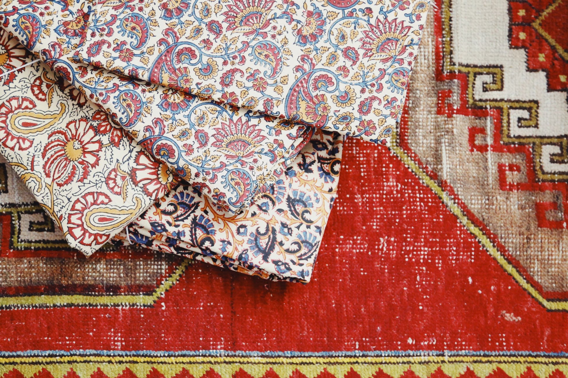 Floral duvet covers stacked on top of rug
