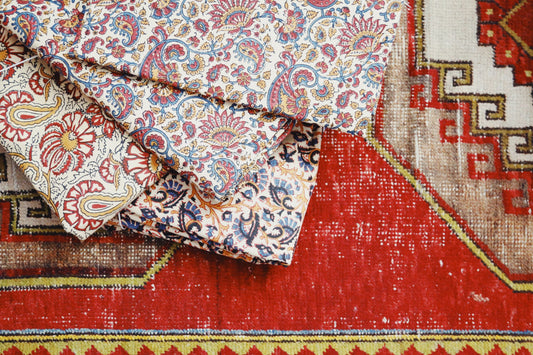 Floral duvet covers stacked on top of rug