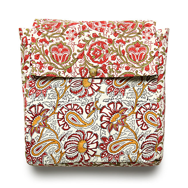 A reversible duvet cover with a floral pattern, featuring red, white, and green colors.