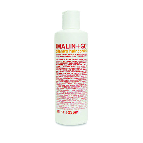 A white bottle of MALIN+GOETZ cilantro hair conditioner with red and black text, detailing product information.