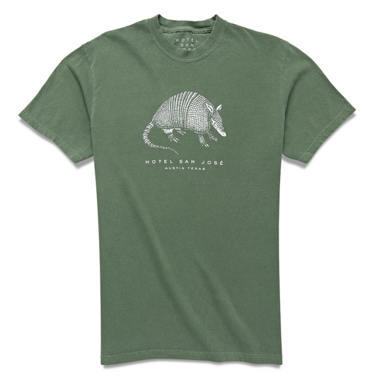 A green unisex crew neck t-shirt with a white printed armadillo design and text 'HOTEL SAN JOSE AUSTIN TEXAS' on the front.