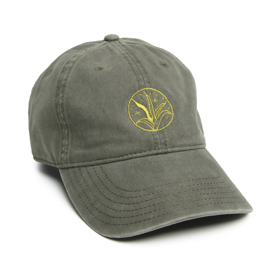 An olive green 'dad hat' with light green embroidery in the shape of an agave plant, featuring an adjustable fabric back strap with a brass buckle.
