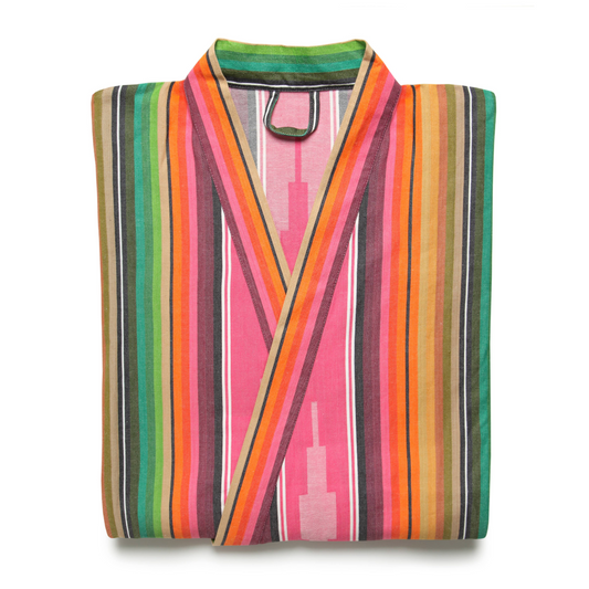 A folded multicolored striped kimono robe against white backdrop
