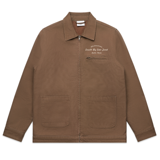 A brown jacket with pockets and a collar, featuring text, '25TH ANNIVERSARY SOUTH BY SAN JOSE AUSTIN TEXAS' on the chest area.
