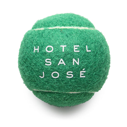 A green tennis ball with the text 'HOTEL SAN JOSÉ' printed on it.