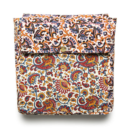 A folded reversible duvet cover with a floral and paisley pattern in multiple colors including orange, blue, green, and brown on a white background.