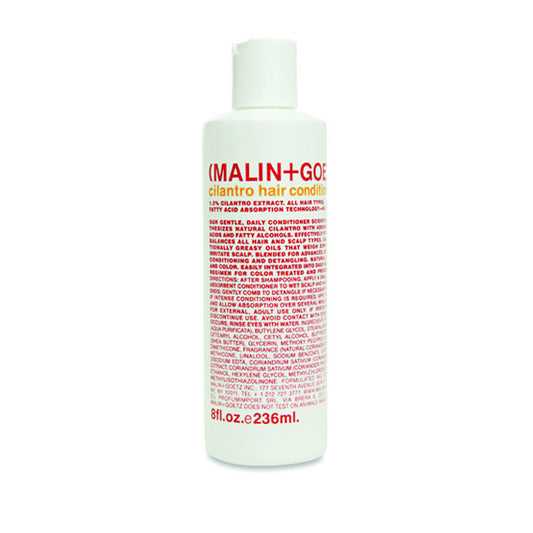A white bottle of MALIN+GOETZ cilantro hair conditioner with red and black text, detailing product information.