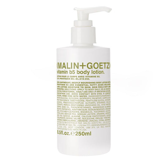 A white pump bottle with green and white labeling for Malin + Goetz Vitamin B5 Body Lotion.